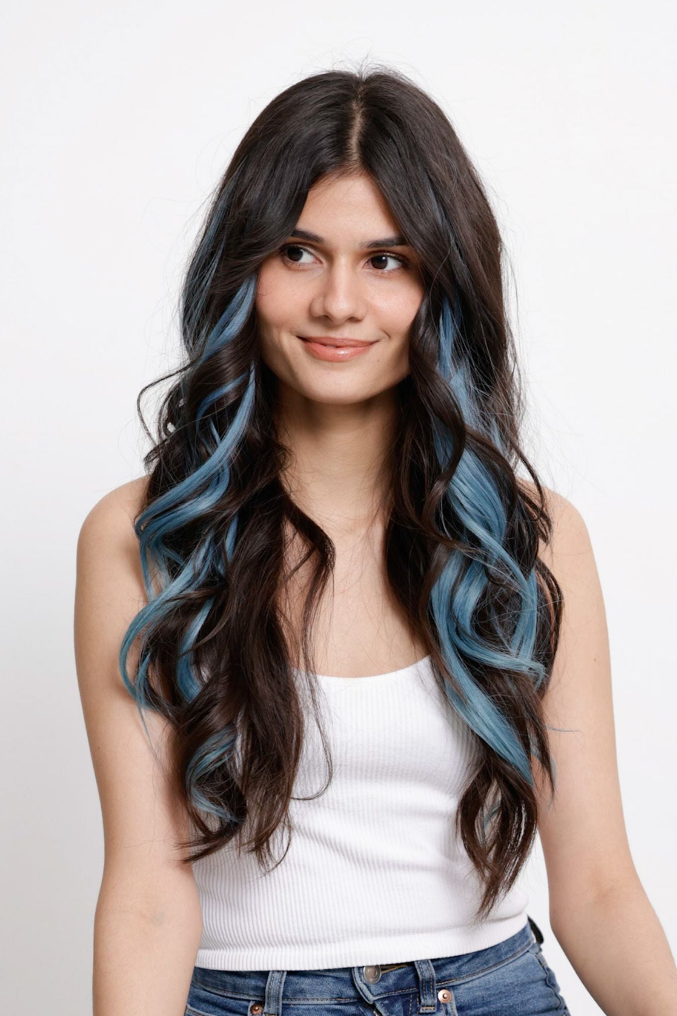Woman with long, wavy hair and blue highlights.
