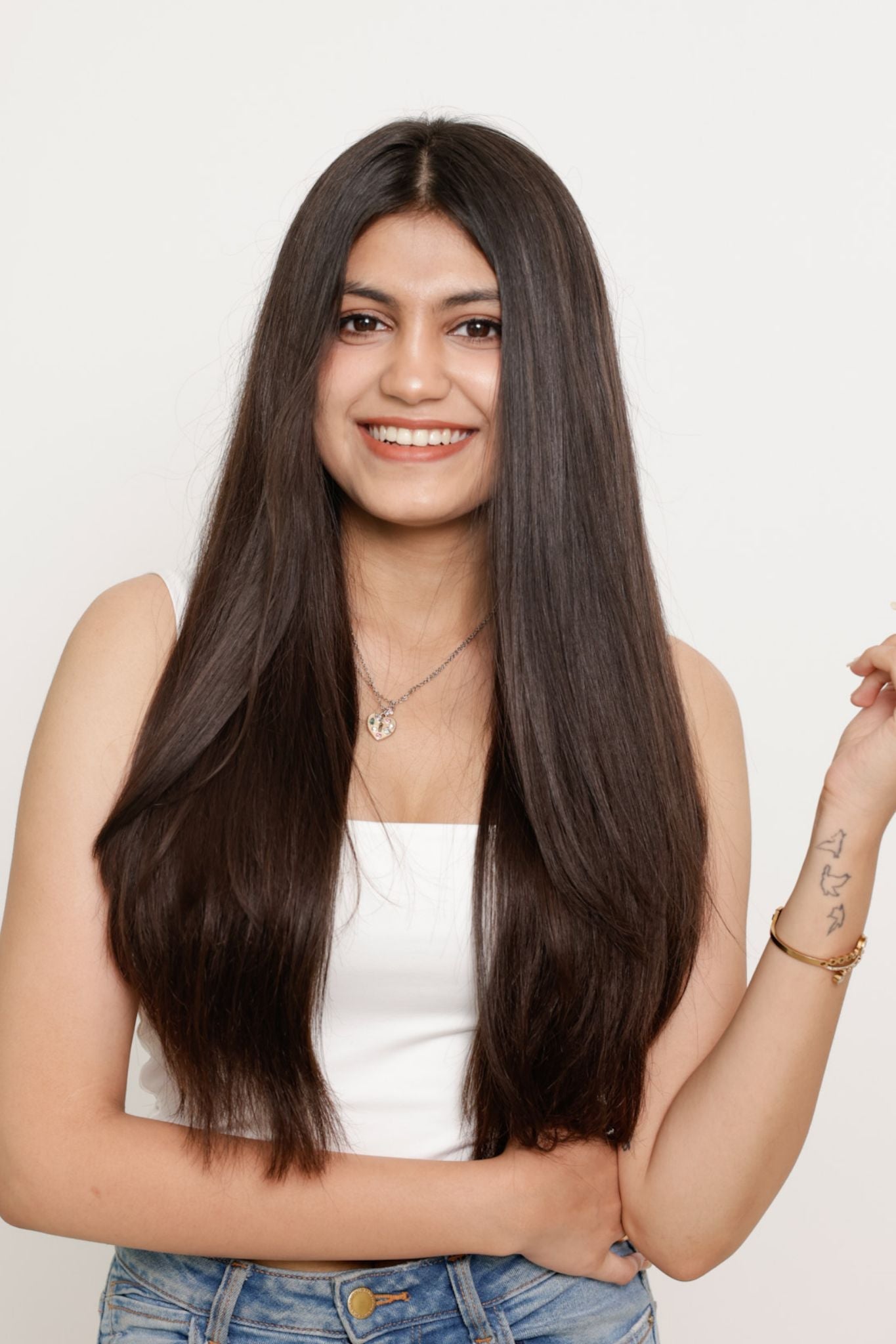 Smiling woman with long, straight hair.