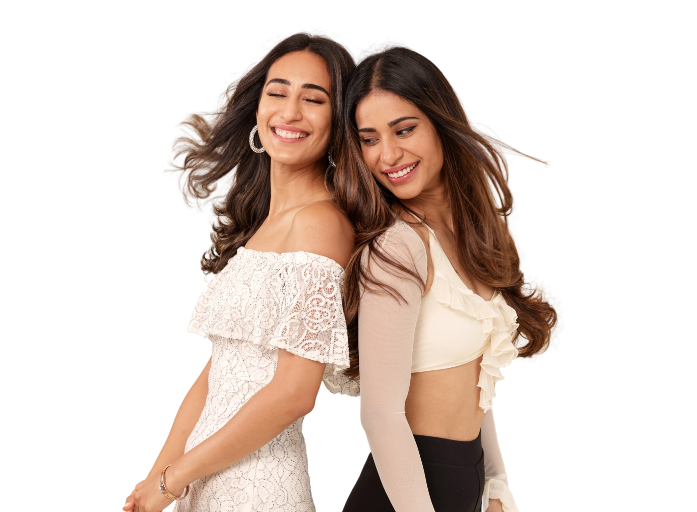 Two women smiling and standing back-to-back.