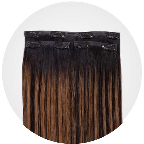Hair extensions with black and brown ombre color, featuring clip-in attachments.