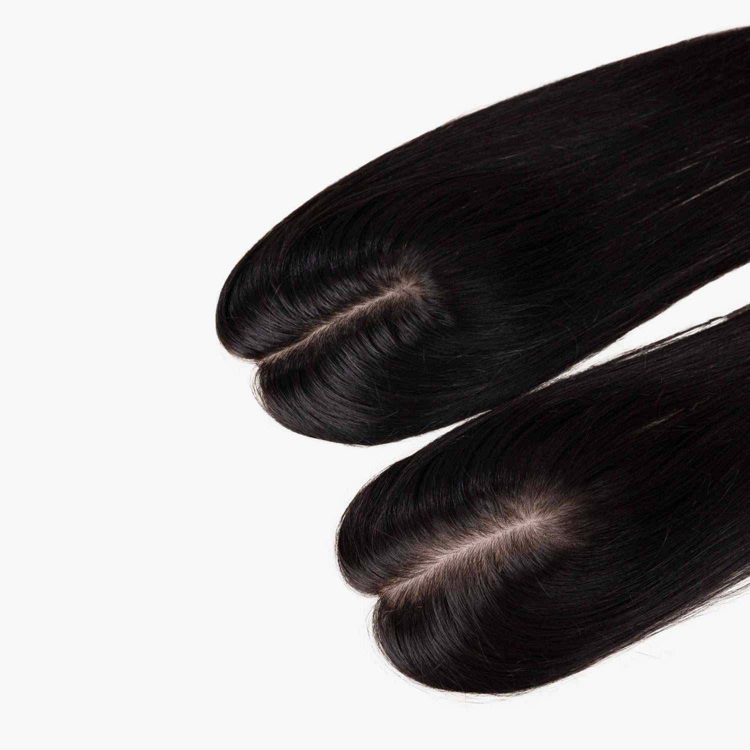 Two black scalp hair toppers with visible parting.