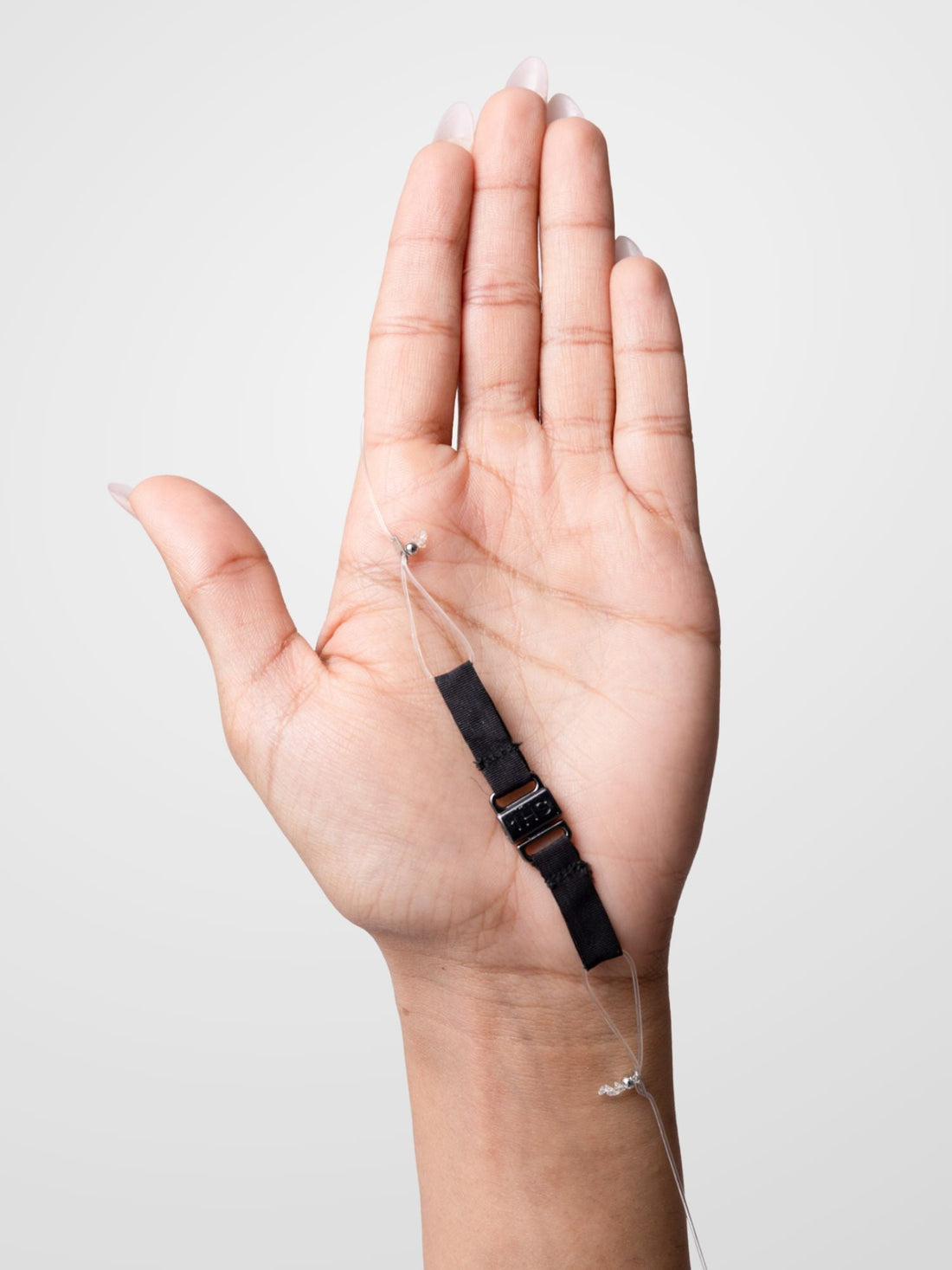 A hand holding an adjustable band.