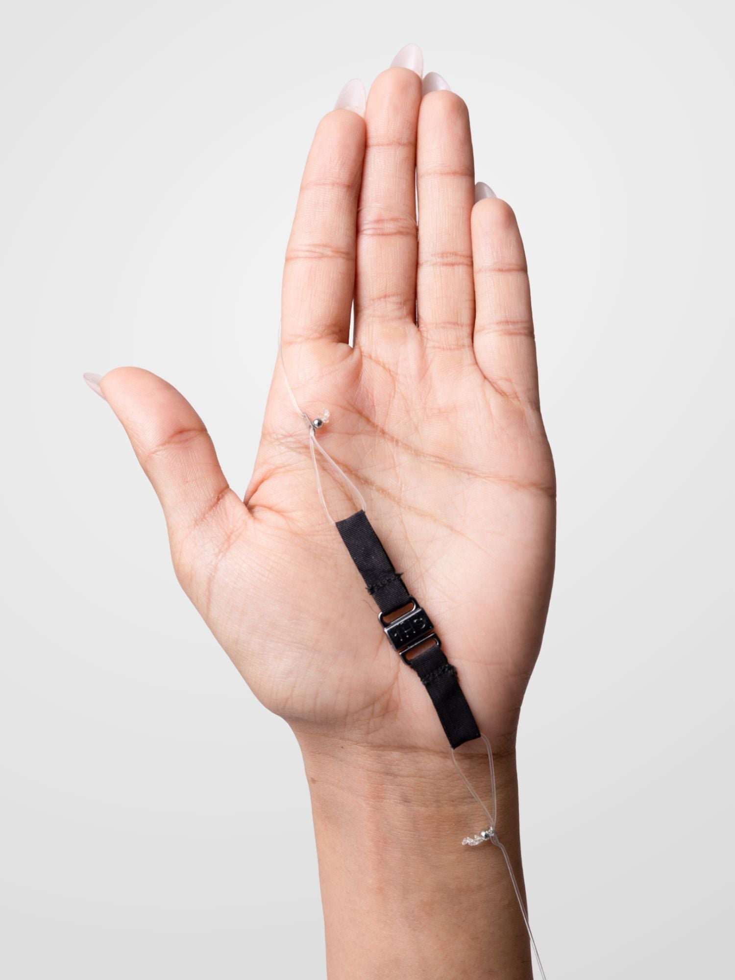 A hand holding an adjustable band.