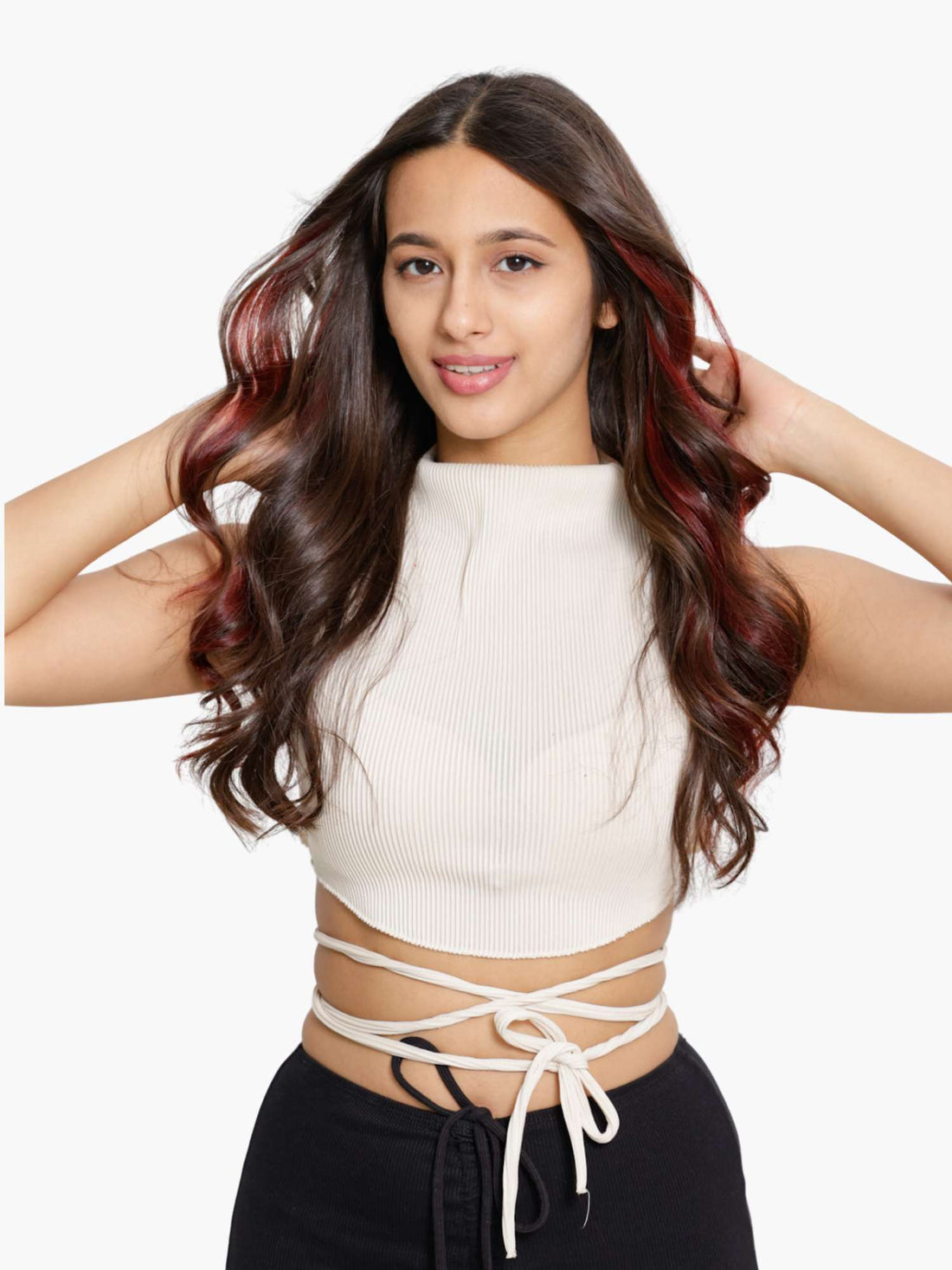 Woman with long, wavy hair styled with burgundy streaks.
