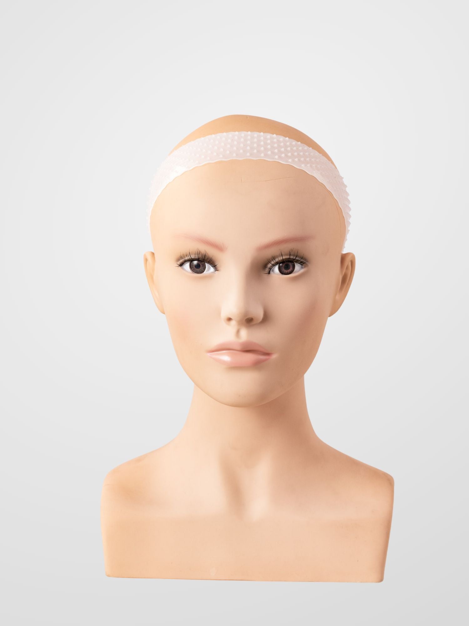A mannequin head wearing a wig grip.