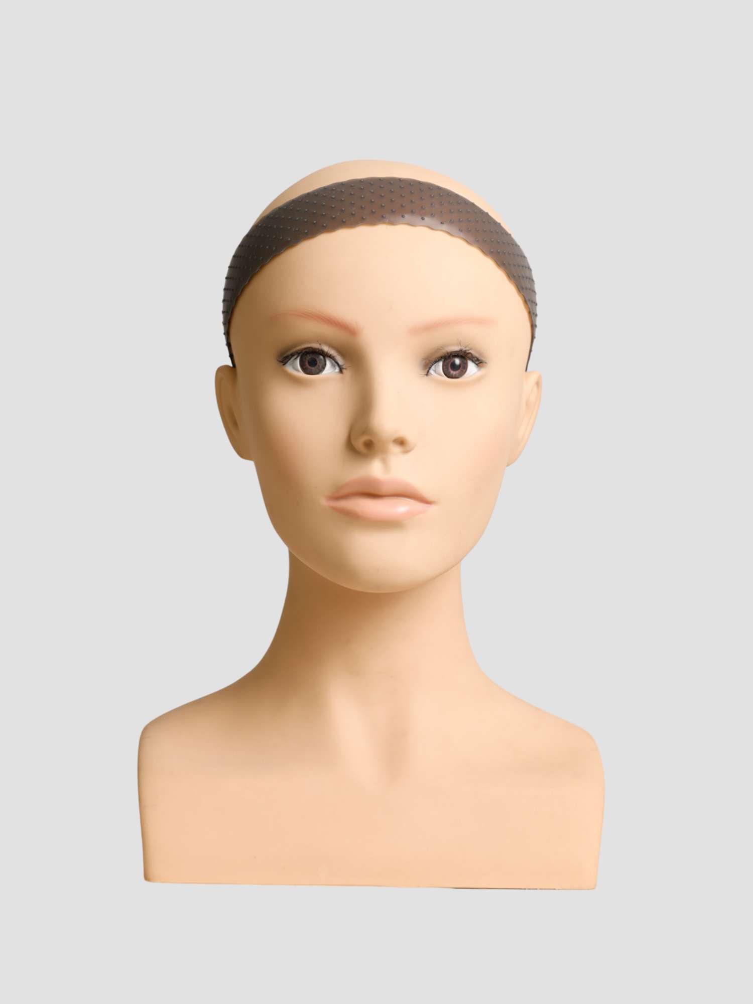 A mannequin head wearing a wig grip.