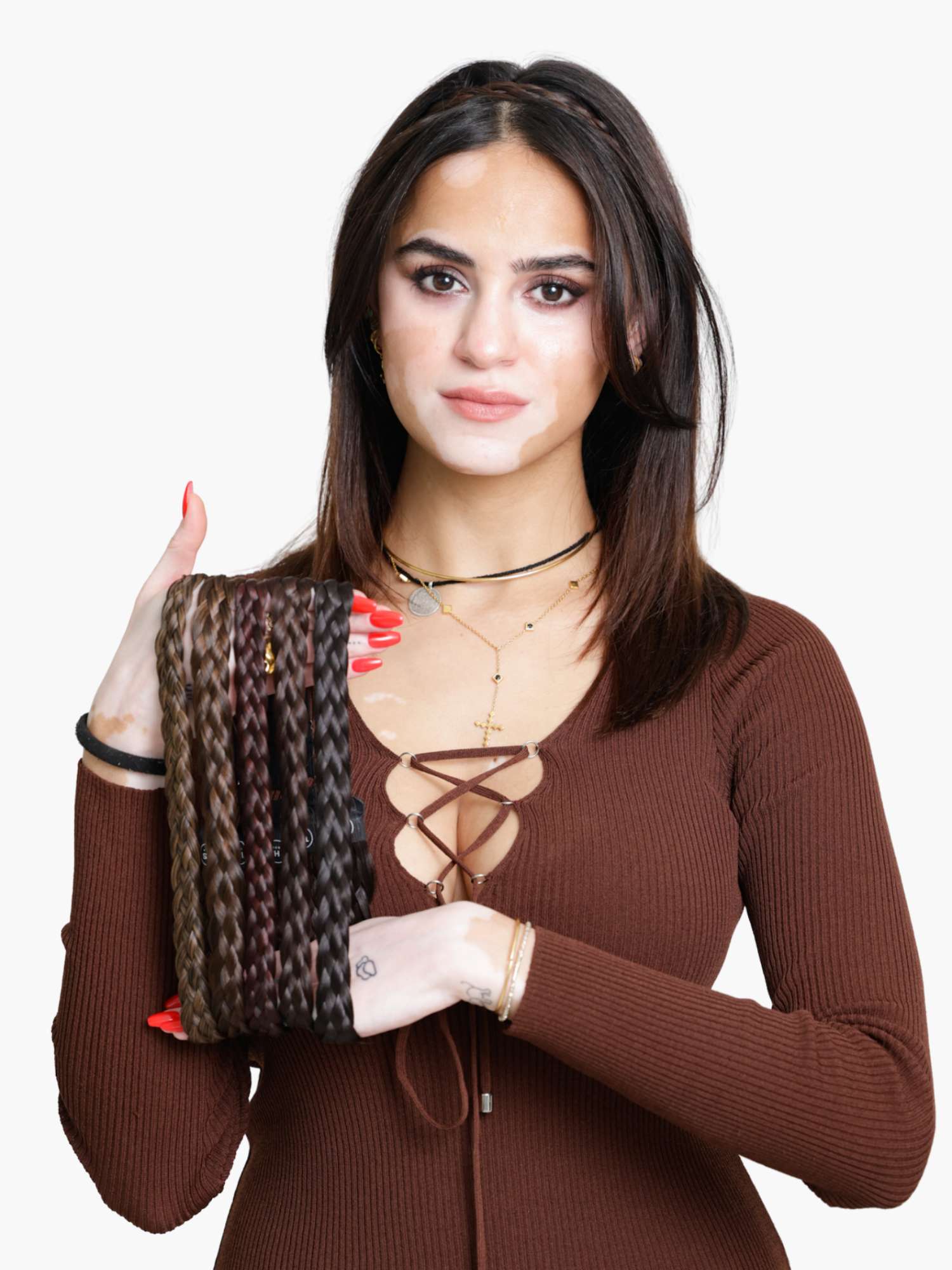 Woman holding a braided hairband.